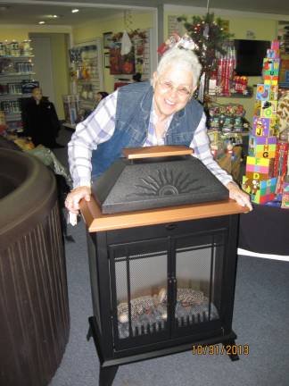 Ann Vanhentenryck won the Outdoor Electric Fireplace and Towel Warmer at Lakeland Poos and Spas. She has been a customer there for almost 10 years and said she will enjoy relaxing in her spa, looking at the fireplace and having a warm towel to wrap around herself.