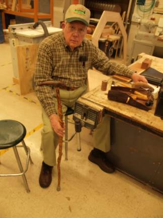 Earl Post of Sparta shows off his cane he carved and designed. The cane is made of red alder wood.