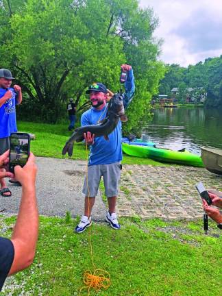 Justin Foglia of Vernon shows off the 17-pound catfish he caught Saturday, July 8.
