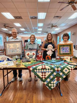 <b>From left, Richard and Barbara Gardiner, Chris Delnero and Barbara Morgan with items for the 78th annual Lord’s Auction on Saturday, Aug. 30. (Photo provided)</b>