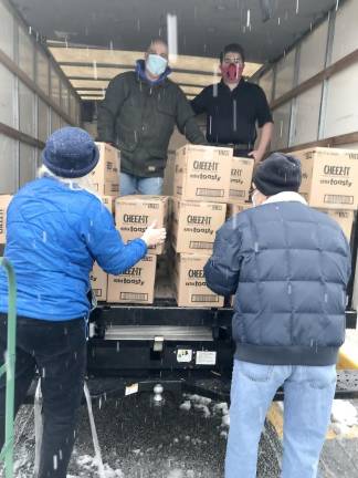 Christian Macchio and Don Lewis unload donations