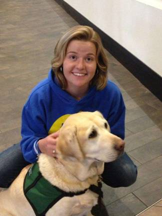 Ashley Craig is shown with a therapy dog at the National Organization of Victim Assistance Conference in Columbus, Ohio, last year.