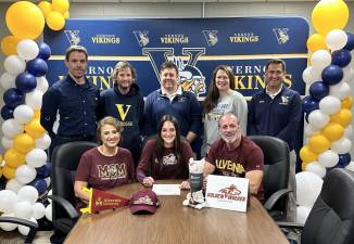 Vernon Township High School senior Makenna Thomas, center, agrees to play lacrosse at Alvernia University next year. Seated with her are her parents, Cyndi and Mike. Standing, from left, are trainer Matt Bergh; Steve Carlson, head girls lacrosse coach; Jim Saganiec, head track coach; Casey Jacoby, assistant lacrosse coach; and Kieran Killeen, head field hockey coach. (Photo provided)