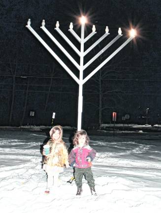 <b>Yael and Staszek Skiba-Quittner of Vernon pose in front of the Menorah.</b>