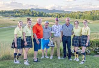 Members of the Pipe &amp; Drum Band stand alongside actor Kelsey Grammer, Harry Phillips of the Police Unity Tour, and winning players Joe Russo and Kevin Convery.