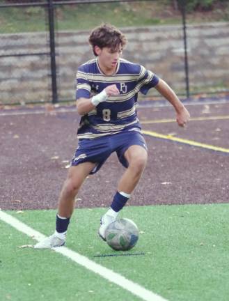 Pope John's Sergio Carabajo controls the ball.