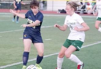 Vernon's Lara O'Toole and Sussex Tech's Catrina Pascale battle for control of the ball