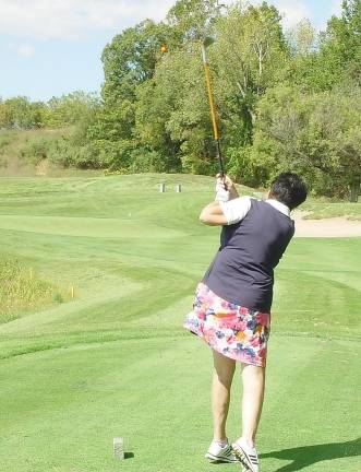Buffy Whiting hits her tee shot on hole #11 using a “Hickory Stick” landing her ball on the green