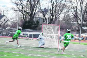 SCL1 Delaware Tech's Shane Sylvester (11) fires the ball past Sussex County's goalie Liam MacClugage, resulting in a score. Sylvester made four goals in the March 17 game, which Delaware Tech won, 19-12. (Photos by George Leroy Hunter)