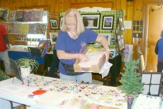 Laura Branigan, the Spider Lady arranges her custom- made spider Christmas tree ornaments at the Highland Lakes Craft Fair held on Nov.2.