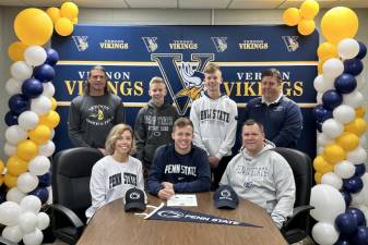 Vernon Township High School senior Zack Mountain, center, agrees to compete in track and field at Penn State next year. Seated with him are his parents, Kristin and Eric. Standing, from left, are Brian McCarthy, head girls track coach; Zack’s brothers, Drew and Ty; and Jim Saganiec, head boys track coach. (Photo provided)