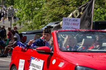 Vincent Scordato, a blind World War II veteran, waves to the cheering audience from a red convertible during the Memorial Day parade Monday, May 29 in Vernon. Several veterans rode in the parade. (Photos by Aja Brandt)