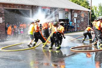 <b>Neighboring fire departments stop by the Pochuck Valley Volunteer Fire Department in Sussex for a dual wetdown celebrating its new equipment Saturday, Aug. 9. (Photos by Maria Kovic)</b>