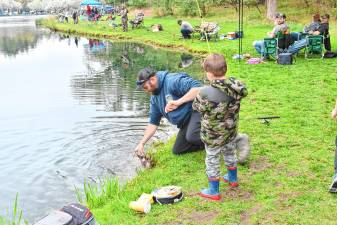 A man reaches in the water to pull up a fish Saturday, April 26 at the 63rd annual Small Fry Trout Fishing Contest at Sussex County Community College in Newton. (Photos by Maria Kovic)