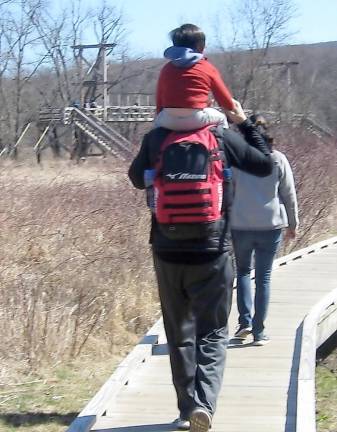A tired hiking youngster gets a boost from dad on the Appalachian Trail on a Sunday afternoon.