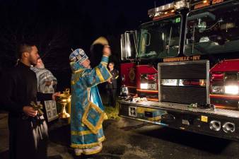 This photo submitted by Mary Osinksy shows Archbishop Michael of New York and New Jersey blessin the Unionville, N.Y., Fire Dept. after the 9/11 Memorial Service at Holy Orthodox Church in Wantage