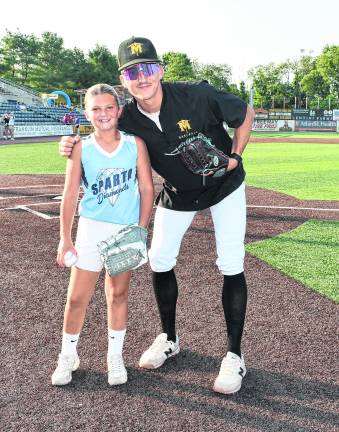 Marissa Post, 9, of Sparta, who threw the ceremonial first pitch, poses with the Sussex County Miners' Jorden Sesar.