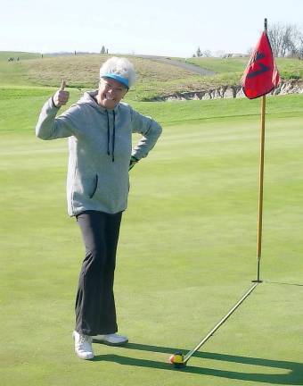 Karen Law poses with her tee shot on the par 3 11th hole that won her closest to the pin honors.