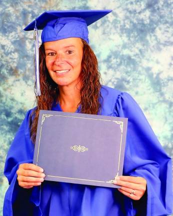 Denise Clarke poses with her diploma.