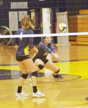 Vernon's Liv Vizzini (21) gets down low to hit the ball towards the other side of the net. Vizzini made 18 assists.