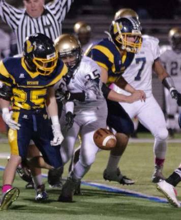 Vernon running back Elvin Febus (25) loses the ball after being grabbed.