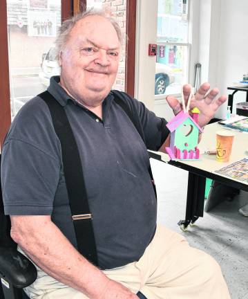 <b>Bryan Mahon of Sussex shows off a birdhouse he built.</b>