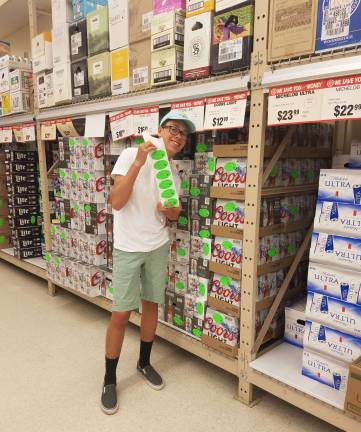 Sebastian Gomez of Sparta High School shows &quot;Sticker Shock&quot; stickers at Franklin Shoprite Wine &amp; Spirits.