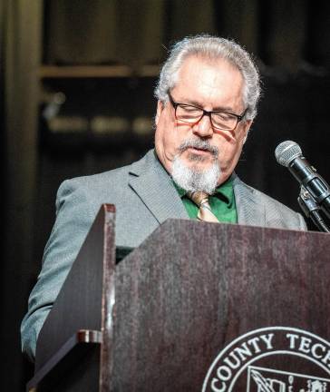 Robert Heiden, president of the Board of Education, speaks at graduation.