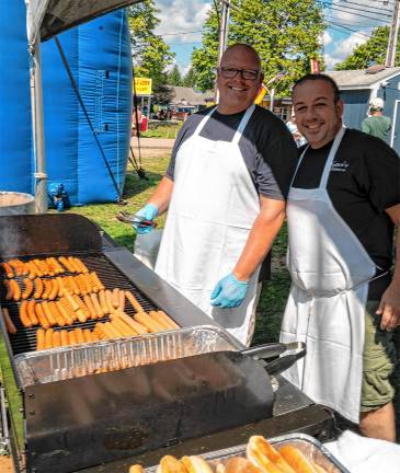 Tommy Hatzinas and Bill Van Putten Vink of Yetter’s Diner in Augusta cook hot dogs for the Sussex County Chamber Scholarship Fund.