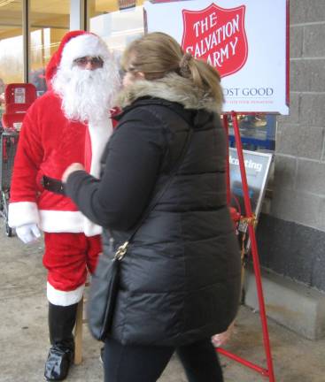 PHOTO BY JANET REDYKEShoppers generously donate to the Salvation Army at the Vernon Acme on a rainy Saturday before Christmas.