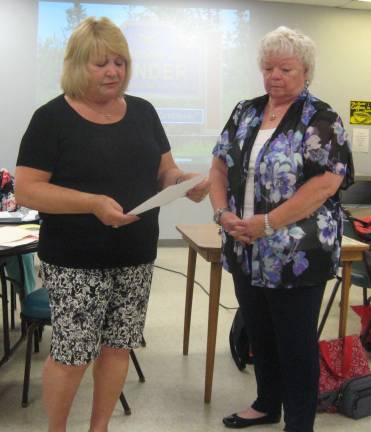Woman&#x2019;s Club First Vice- President Maria Dorsey (left) introduces Vernoy Paolini at the June 28 meeting.