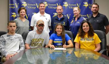 Seated, from left: Brother Johnnie, Father John Kowalski,Caitlyn and Mom Gina Kowalski; standing, from left, Dr. Pauline Anderson, AD Bill Foley, Head Lacrosse Coach Steve Carlson, Assistant Lacrosse Coach Hollyce Schoepp and Head Field Hockey Coach Kieran Killeen