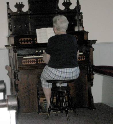 Marilyn Slate practices hymns for the annual service at the church.