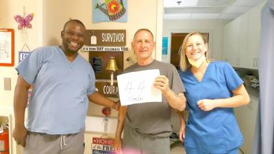 Cancer survivor Gary Gardner, after his 44th prostate cancer treatment with some of the hospital staff members.