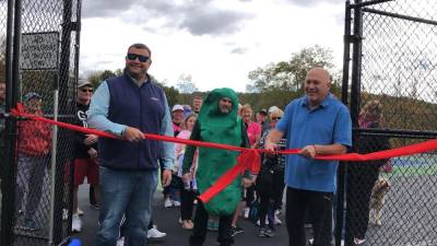 Councilman Ronald Bassani prepares to cut the ribbon at the opening of the pickleball courts at Woodbourne Park in Wantage on Sunday, Oct. 8. At left is Warren Wisse, president of the Recreation and Parks Advisory Committee. (Photos by Kathy Shwiff)