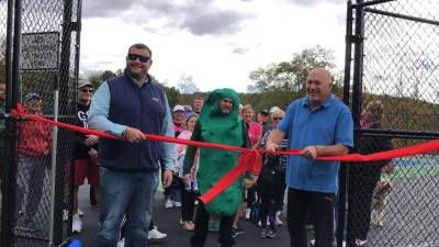 Councilman Ronald Bassani prepares to cut the ribbon at the opening of the pickleball courts at Woodbourne Park in Wantage on Sunday, Oct. 8. At left is Warren Wisse, president of the Recreation and Parks Advisory Committee. (Photos by Kathy Shwiff)