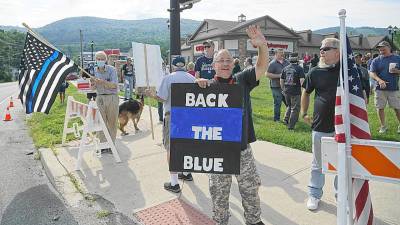 Organizer Martin O'Donnell with Back the Blue sign.