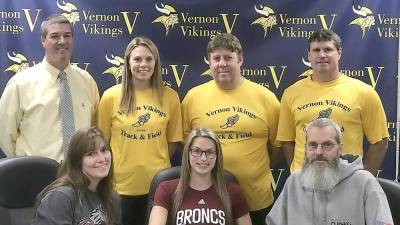 Seated, from left: Mrs. Wilkens, Jessica Wilkens and Mr. Wilkens. Standing left to right: AD Bill Foley, Assistant Coach Stephanie DePiano, Head Coach Jim Saganiec and Assistant Coach Brian McCarthy.