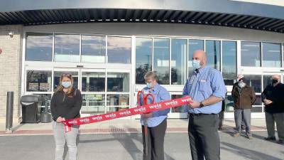 Store manager Amy Zimmerman with two employees get ready to cut the ribbon at the Market Community Day Celebration in Dingmans Ferry (Photo by Marilyn Rosenthal)
