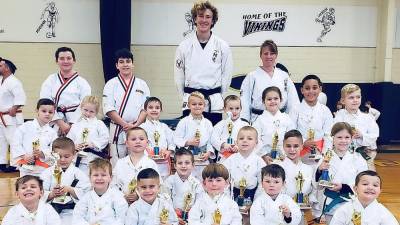 Ranger level students show off the trophies they won for their Kata performances.