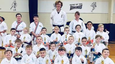 Ranger level students show off the trophies they won for their Kata performances.