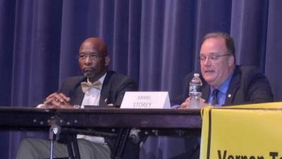 Mayoral candidate Daniel Storey, right, speaks while fellow candidate Howard Burrell listens during Wednesday's candidate forum at Vernon Township High School.