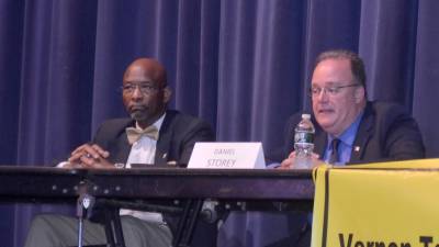 Mayoral candidate Daniel Storey, right, speaks while fellow candidate Howard Burrell listens during Wednesday's candidate forum at Vernon Township High School.