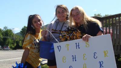 Members of the Vernon Township High School Varsity Cheerleaders (from left) Julia Hagedoorn, Theresa Auletta and Faith Waller encourage Saturday drivers to have their cars washed at a benefit car wash held at the McAfee Firehouse