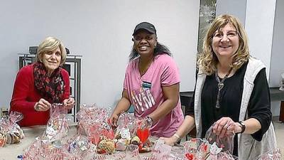 Vernon Township Woman’s Club members, from left, Elaine Kuntz, Rosetta Patterson and Karen Rothstadt display some of the 169 bags of homemade cookies their club donated to The Homestead Rehabilitation and Health Care Center in Newton.