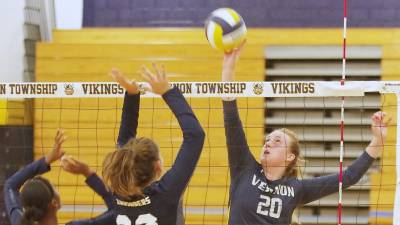 Vernon's Kaitlyn Buurman hits the ball above the net. Buurman accomplished 6 kills, 16 digs and 2 aces.