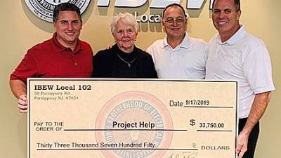 IBEW Local 102 Treasurer Dave Fiore, Project Help Executive Director Sandy Mitchell, IBEW Local 102 Business Representative Mike Scotto, and IBEW Local 102 President Bernie Corrigan.