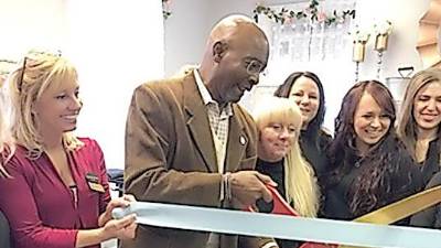 Vernon Township Mayor Howard Burrell cuts the ribbon at Magnolia' Beauty Boutique.