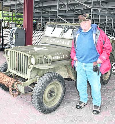 <b>Tom Lambiase of Roxbury stands in front of a vehicle.</b>