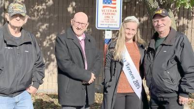 From left, Vietnam veteran Owen Martin, Vernon Township Mayor Harry Shortway, Hannah Van Blarcom and Vietnam veteran John Harrigan. stand in front of one of the new veteran Parking Only signs.